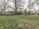Expansive grassy backyard with mature trees and planting beds at 57 Worman St, Indianapolis, IN 46227
