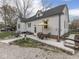 Charming backyard with patio seating, mature trees, and landscaped flower beds at 57 Worman St, Indianapolis, IN 46227