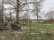 The garden area in the backyard offers a peaceful retreat with a bench and metal arbor at 57 Worman St, Indianapolis, IN 46227