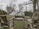 Inviting backyard featuring a brick fire pit and cozy wooden Adirondack chairs at 57 Worman St, Indianapolis, IN 46227