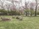Large backyard with firepit, picnic table and mature trees provides an ideal outdoor retreat at 57 Worman St, Indianapolis, IN 46227