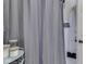 Bathroom featuring a shower with gray tile and a storage unit with white towels at 57 Worman St, Indianapolis, IN 46227