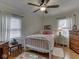 Comfortable bedroom featuring hardwood floors, a white metal bed frame, and natural light at 57 Worman St, Indianapolis, IN 46227