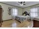 Cozy bedroom with hardwood floors, a floral quilt, and sheer curtains for natural light at 57 Worman St, Indianapolis, IN 46227