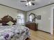 Charming bedroom with hardwood floors, a floral quilt, and a vintage-style dresser at 57 Worman St, Indianapolis, IN 46227