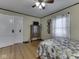 Inviting bedroom with hardwood floors, a floral quilt, and a classic armoire at 57 Worman St, Indianapolis, IN 46227
