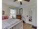 Comfortable bedroom featuring hardwood floors, a white metal bed frame, and natural light at 57 Worman St, Indianapolis, IN 46227