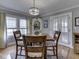 Charming dining room features a chandelier, hardwood floors, and natural light from the windows at 57 Worman St, Indianapolis, IN 46227