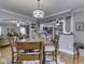 Dining area with a light fixture, four chairs, and an open view into the living room and kitchen at 57 Worman St, Indianapolis, IN 46227