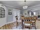 An open dining room with hardwood floors, a chandelier, and access to the living room at 57 Worman St, Indianapolis, IN 46227