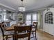 Dining area with light-colored walls and floors, a chandelier, and a view into the kitchen at 57 Worman St, Indianapolis, IN 46227