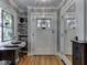 Bright entryway with hardwood floors, built-in shelves, and a decorative stained-glass window at 57 Worman St, Indianapolis, IN 46227