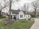 Picturesque home with a well-manicured lawn, mature trees, and a covered porch at 57 Worman St, Indianapolis, IN 46227