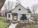Charming home featuring a covered porch, colorful accents, and well-maintained landscaping at 57 Worman St, Indianapolis, IN 46227