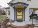 Charming home featuring a covered porch and colorful accents, creating a welcoming entrance at 57 Worman St, Indianapolis, IN 46227