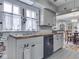 The kitchen has a stainless steel sink, wood countertops, and gray cabinets with an opening to the dining room at 57 Worman St, Indianapolis, IN 46227