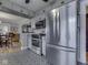 Bright kitchen featuring stainless steel appliances, gray cabinets, and a patterned floor at 57 Worman St, Indianapolis, IN 46227