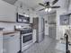 Updated kitchen with stainless steel appliances, stylish gray cabinetry, and decorative tile flooring at 57 Worman St, Indianapolis, IN 46227
