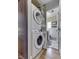 Convenient laundry area with stacked washer and dryer, leading to a bathroom space at 57 Worman St, Indianapolis, IN 46227