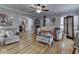 Cozy living room with hardwood floors, ceiling fan, an arched doorway, and neutral-colored furniture at 57 Worman St, Indianapolis, IN 46227