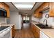 Well-lit kitchen with wood cabinets and sightlines to a living room and the outdoors at 572 Eagle Crest Dr, Brownsburg, IN 46112