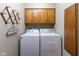 Laundry room with washer, dryer, and overhead cabinets at 572 Eagle Crest Dr, Brownsburg, IN 46112