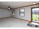 Spacious living room featuring neutral carpet, trim, and a ceiling fan at 572 Eagle Crest Dr, Brownsburg, IN 46112