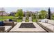 Backyard patio featuring a fire pit, outdoor furniture, manicured lawn, and lush landscaping at 5869 Belchamp Dr, Noblesville, IN 46062