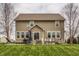 Spacious backyard with lush lawn and a patio featuring outdoor seating and a fire pit at 5869 Belchamp Dr, Noblesville, IN 46062