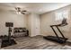 Finished basement featuring a treadmill, workout equipment, and wood-look flooring at 5869 Belchamp Dr, Noblesville, IN 46062
