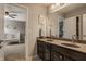 Bathroom featuring a double sink vanity with a view into the bedroom at 5869 Belchamp Dr, Noblesville, IN 46062