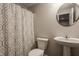 Cozy bathroom featuring a pedestal sink, framed round mirror, toilet and shower/tub combination at 5869 Belchamp Dr, Noblesville, IN 46062