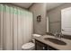 Well-lit bathroom featuring a stylish vanity, toilet, and shower with decorative curtain at 5869 Belchamp Dr, Noblesville, IN 46062