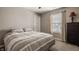 Comfortable bedroom with neutral walls, plush carpet, large window, and striped comforter at 5869 Belchamp Dr, Noblesville, IN 46062