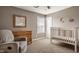 Bedroom featuring neutral paint, a wooden dresser, and a crib at 5869 Belchamp Dr, Noblesville, IN 46062