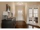 Warm foyer with hardwood floors, elegant lighting, and a stylish console table at 5869 Belchamp Dr, Noblesville, IN 46062