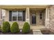 Charming front porch with stone accents, decorative wreath, and well-maintained landscaping at 5869 Belchamp Dr, Noblesville, IN 46062