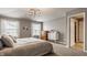 Bright main bedroom featuring two windows, soft neutral colors, and an en suite bathroom at 5869 Belchamp Dr, Noblesville, IN 46062