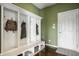 Functional mudroom with built-in storage, cubbies, bench, and hardwood floors at 5869 Belchamp Dr, Noblesville, IN 46062