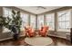 Cozy sunroom with hardwood floors, large windows and comfortable armchairs at 5869 Belchamp Dr, Noblesville, IN 46062