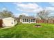 A verdant backyard featuring a fire pit, shed, screened-in porch and manicured lawn at 590 N 17Th St, Noblesville, IN 46060