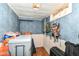 Unfinished basement area with storage, blue walls, and a drop ceiling at 590 N 17Th St, Noblesville, IN 46060