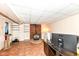 Finished basement area with a wood-burning stove, shelving, and an office setup at 590 N 17Th St, Noblesville, IN 46060