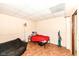 Minimalist basement space with a single bed, seating and vinyl flooring at 590 N 17Th St, Noblesville, IN 46060