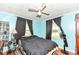 Tranquil bedroom with a ceiling fan, large windows, and dark blackout curtains at 590 N 17Th St, Noblesville, IN 46060