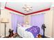 Bright bedroom with stuffed animals, colorful blanket, and bedside decor at 590 N 17Th St, Noblesville, IN 46060