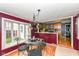 Dining area showcases a stylish chandelier, large windows, and seamless flow to the kitchen at 590 N 17Th St, Noblesville, IN 46060