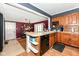 Open kitchen area with a breakfast bar, wood cabinets, and easy access to the dining area at 590 N 17Th St, Noblesville, IN 46060