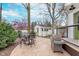 Landscaped backyard with dining set, barbecue grill, patio, garden shed, manicured lawn, and lush greenery at 5942 Primrose Ave, Indianapolis, IN 46220