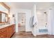 Bright bathroom featuring a tub/shower combo, modern vanity, and access to the main bedroom, creating a relaxing retreat at 5942 Primrose Ave, Indianapolis, IN 46220